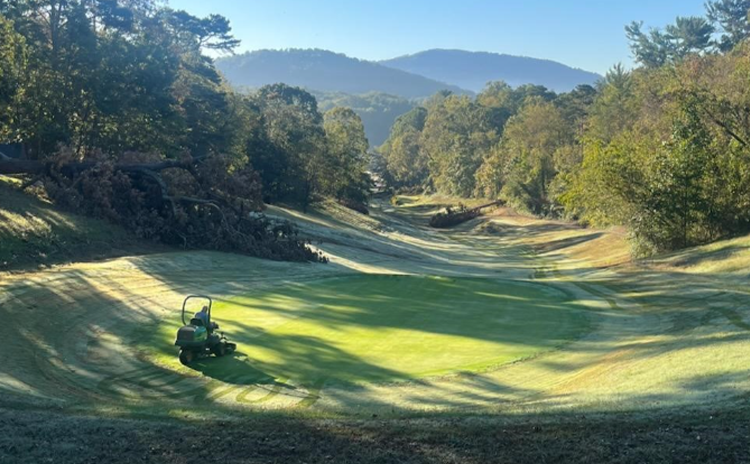 Golf cart manicuring fairway greens
